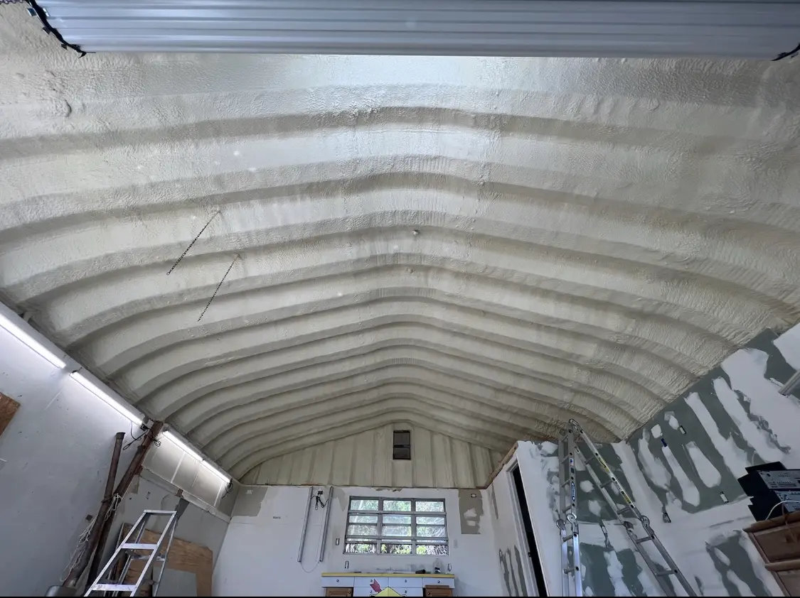 Spray polyurethane foam applied to the underside of a metal roof deck in Garrison